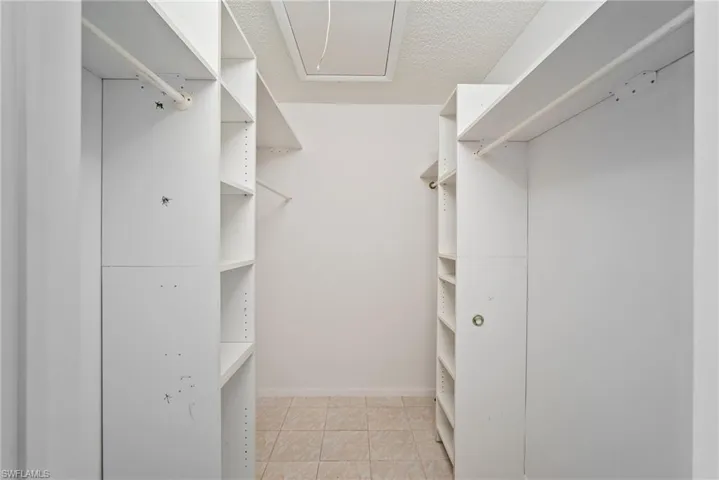 Walk in closet featuring light tile patterned flooring