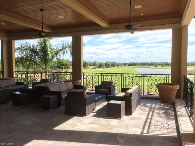 View of patio / terrace featuring outdoor lounge area, ceiling fans, water and golf course views.