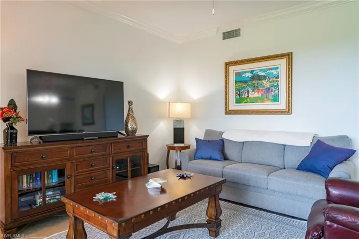 Living room with ornamental molding.