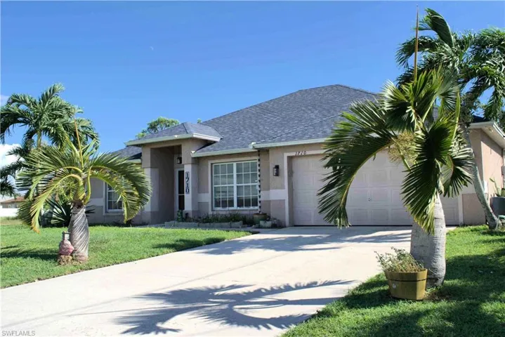 Single story home featuring stucco siding, a front yard, concrete driveway, a shingled roof, and an attached garage
