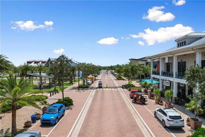 View of decorative street with sidewalks, street lights, and curbs
