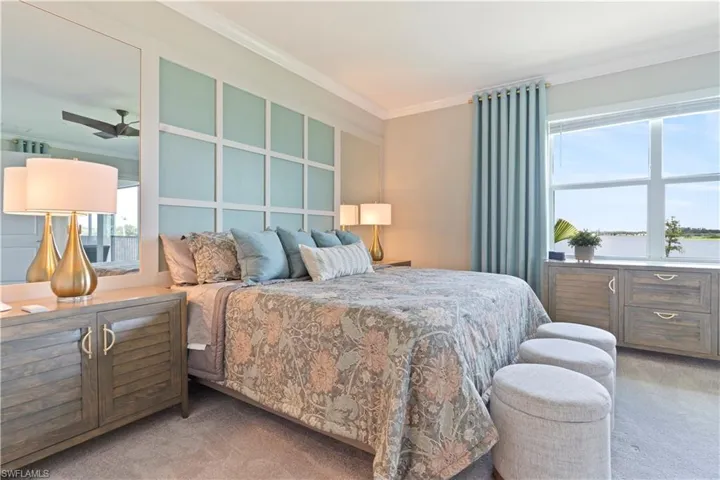 Bedroom with light colored carpet and crown molding