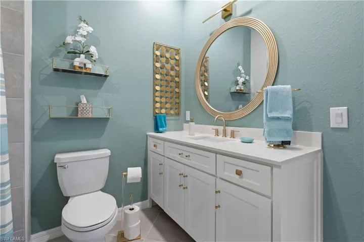 Full bathroom featuring tile patterned flooring and vanity