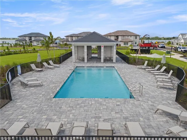 Community pool featuring a gazebo, a patio area, and a residential view