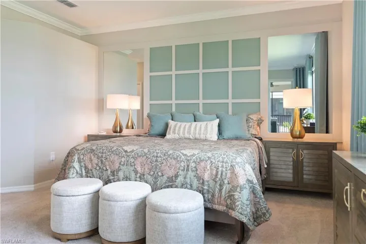 Carpeted bedroom with crown molding