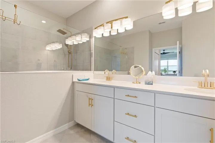 Bathroom with double vanity and a walk in shower