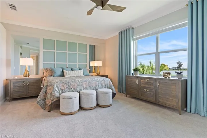 Carpeted bedroom with crown molding and ceiling fan