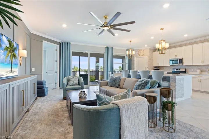 Living area with a chandelier, light tile patterned flooring, crown molding, a ceiling fan, and recessed lighting