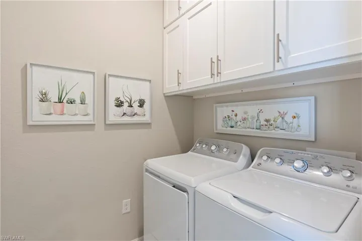 Laundry room with cabinet space and washing machine and clothes dryer
