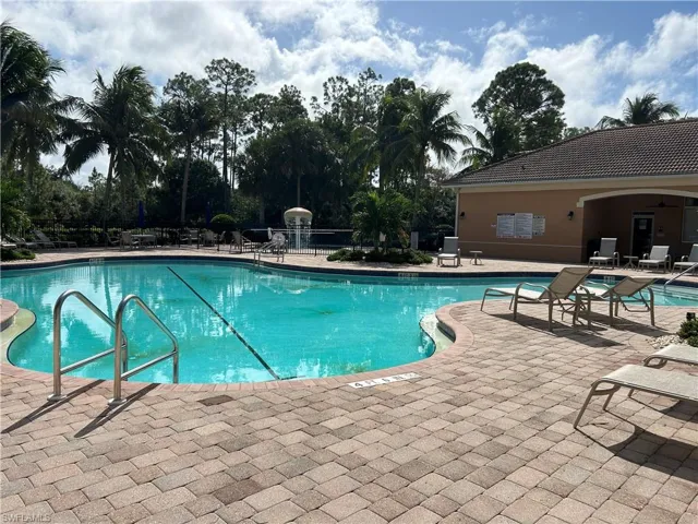 Community pool with a patio
