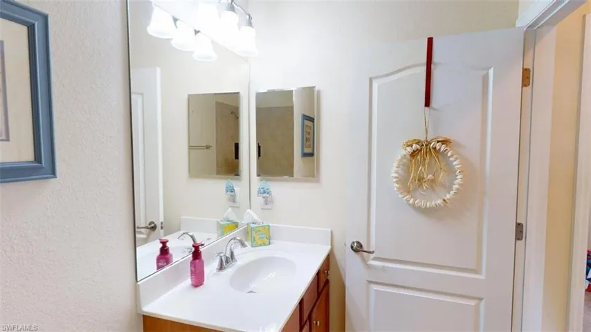 Bathroom featuring a chandelier and vanity