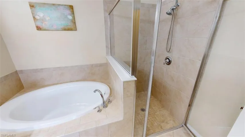 Bathroom with a stall shower and a bath