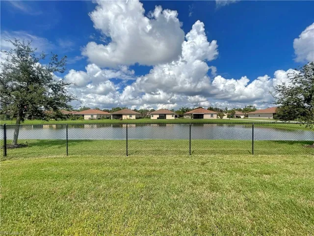 View of yard with a lake view.
