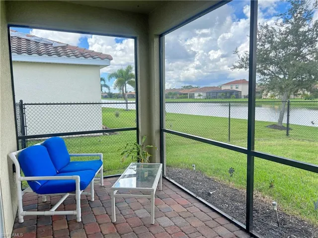 Sunroom / solarium featuring a water view