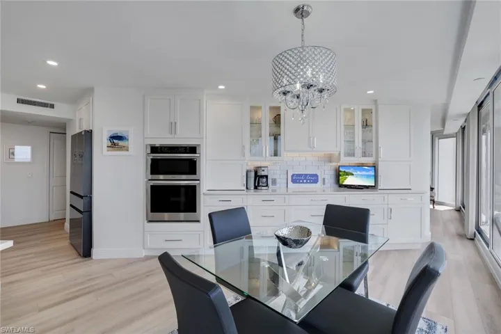 Dining space featuring a chandelier, recessed lighting, light wood finished floors, and baseboards