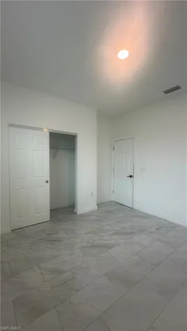 Unfurnished bedroom with a closet and baseboards