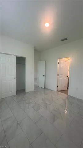 Unfurnished bedroom featuring a closet and baseboards