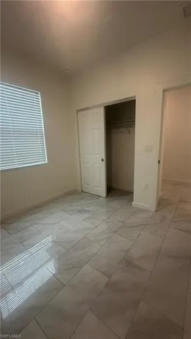 Unfurnished bedroom with baseboards and a closet