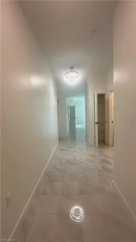 Corridor featuring baseboards