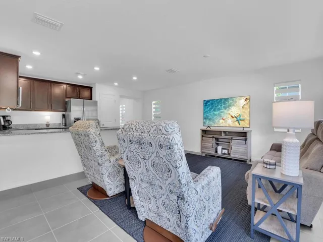 Living area with visible vents, recessed lighting, and light tile patterned floors