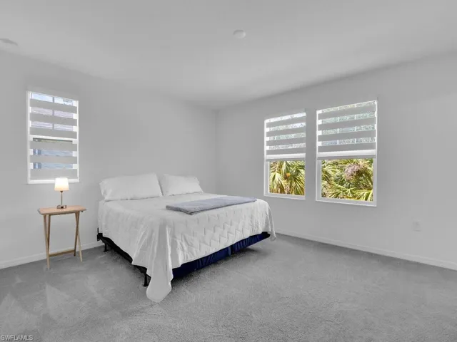 Carpeted bedroom featuring baseboards