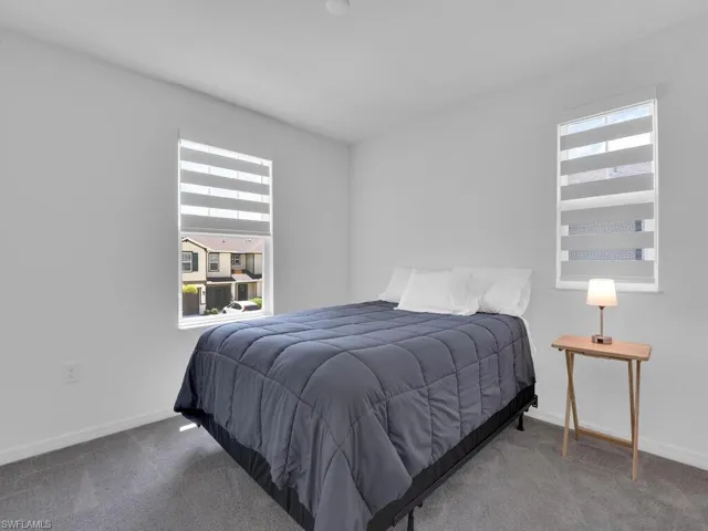 Bedroom featuring baseboards and carpet flooring
