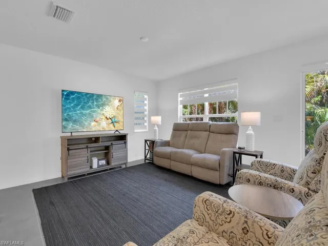 Living area with baseboards and visible vents