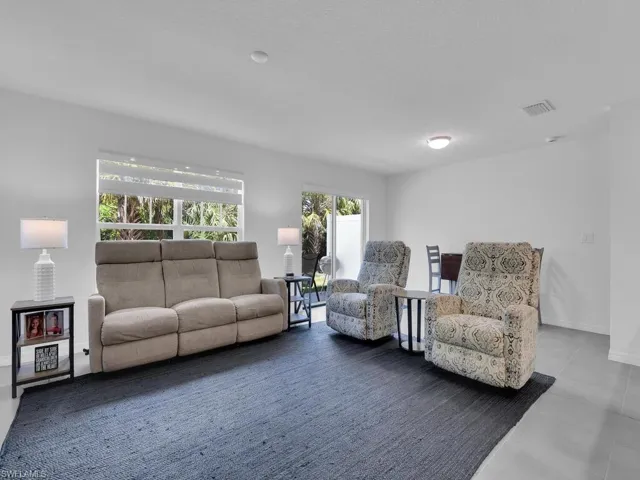Living area featuring baseboards and visible vents