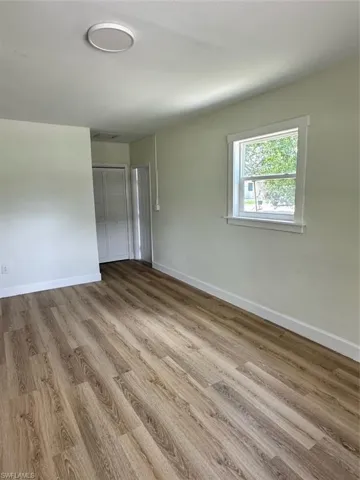 Empty room featuring wood-type flooring