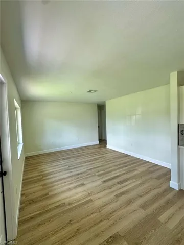Unfurnished room featuring hardwood / wood-style floors