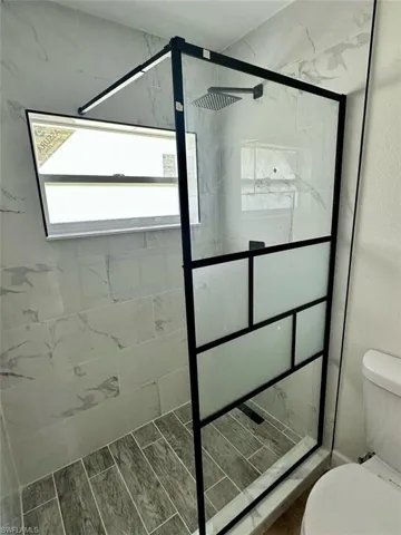 Bathroom with a tile shower and toilet