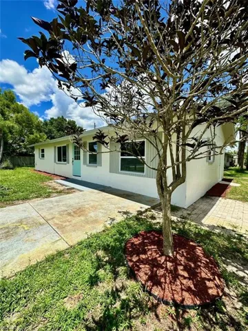 View of front of property with a front yard and a patio