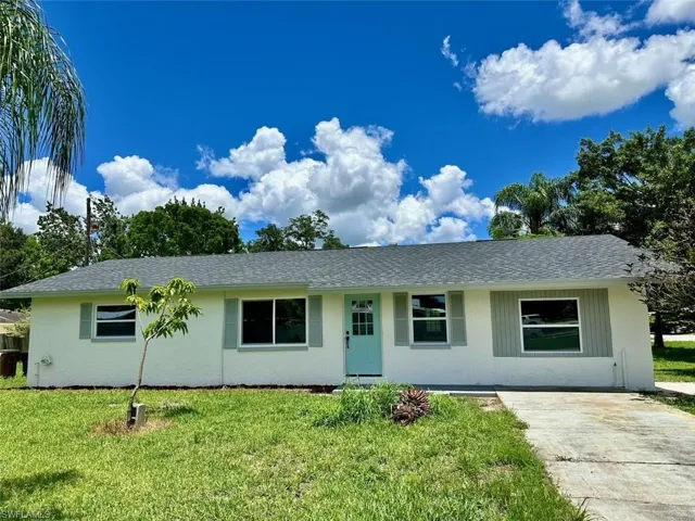 Ranch-style home featuring a front lawn