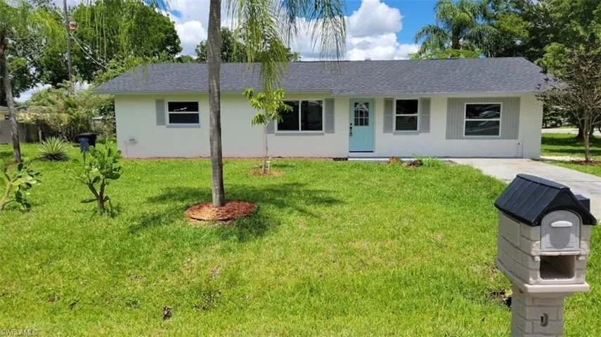 Ranch-style home with a front yard