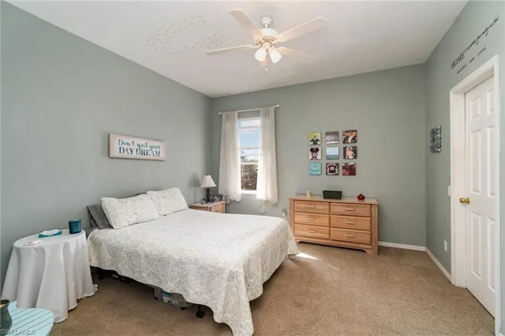 Carpeted bedroom with ceiling fan