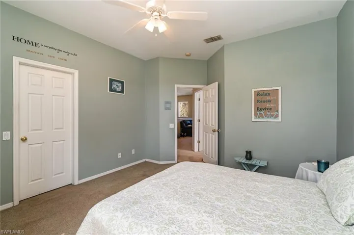 Bedroom with ceiling fan and carpet
