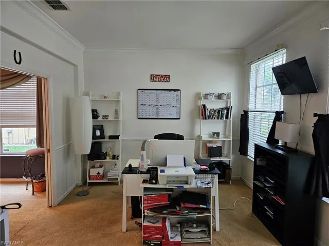 Office with crown molding and carpet floors