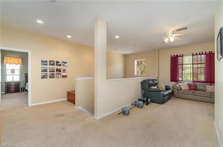 Living room with light carpet and ceiling fan