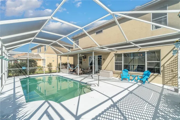 View of pool with a patio area and a lanai