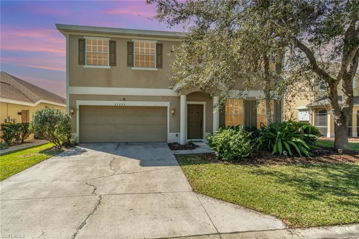 View of front property with a yard and a garage