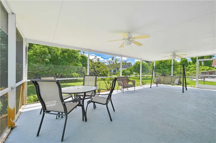 Sunroom featuring ceiling fan, healthy amount of natural light, and outdoor dining space