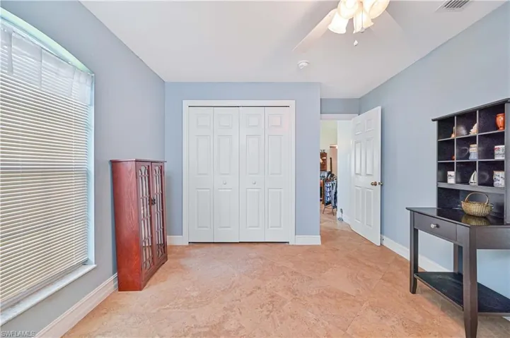 Bedroom with a ceiling fan and a closet