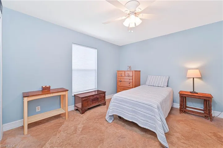 Bedroom with ceiling fan and baseboards