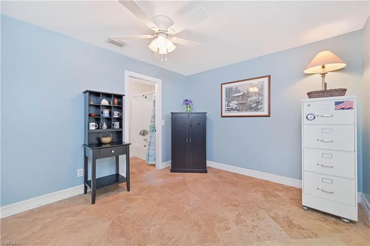 Living area with baseboards and a ceiling fan