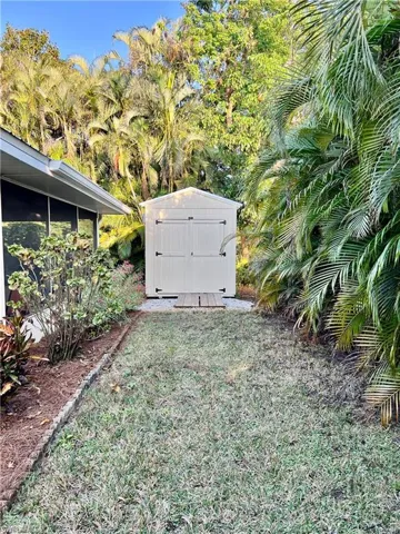 View of yard featuring a storage unit