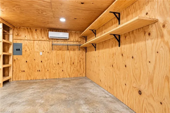 Plywood-paneled walls and ceiling with recessed lighting
