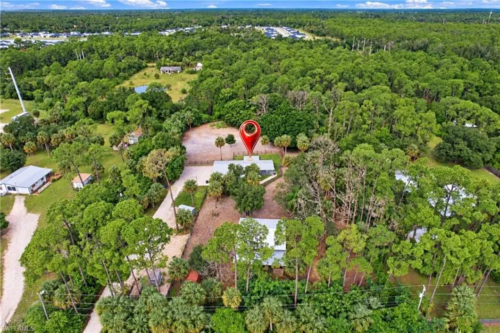 Extensive wooded parcel with multiple structures and a private pond