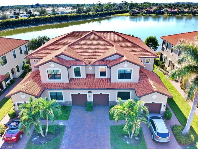 View of front of home featuring a garage and a water view