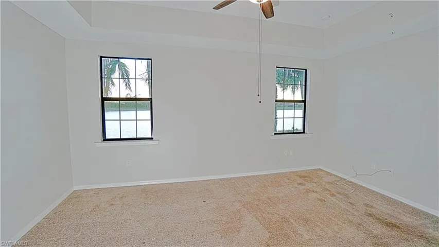 Empty room featuring carpet floors and ceiling fan
