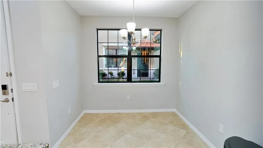 Unfurnished dining area with a notable chandelier